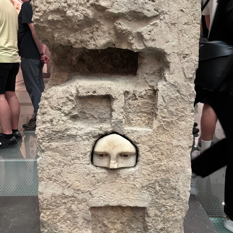 Eyes and a nose carved into a marble structure.