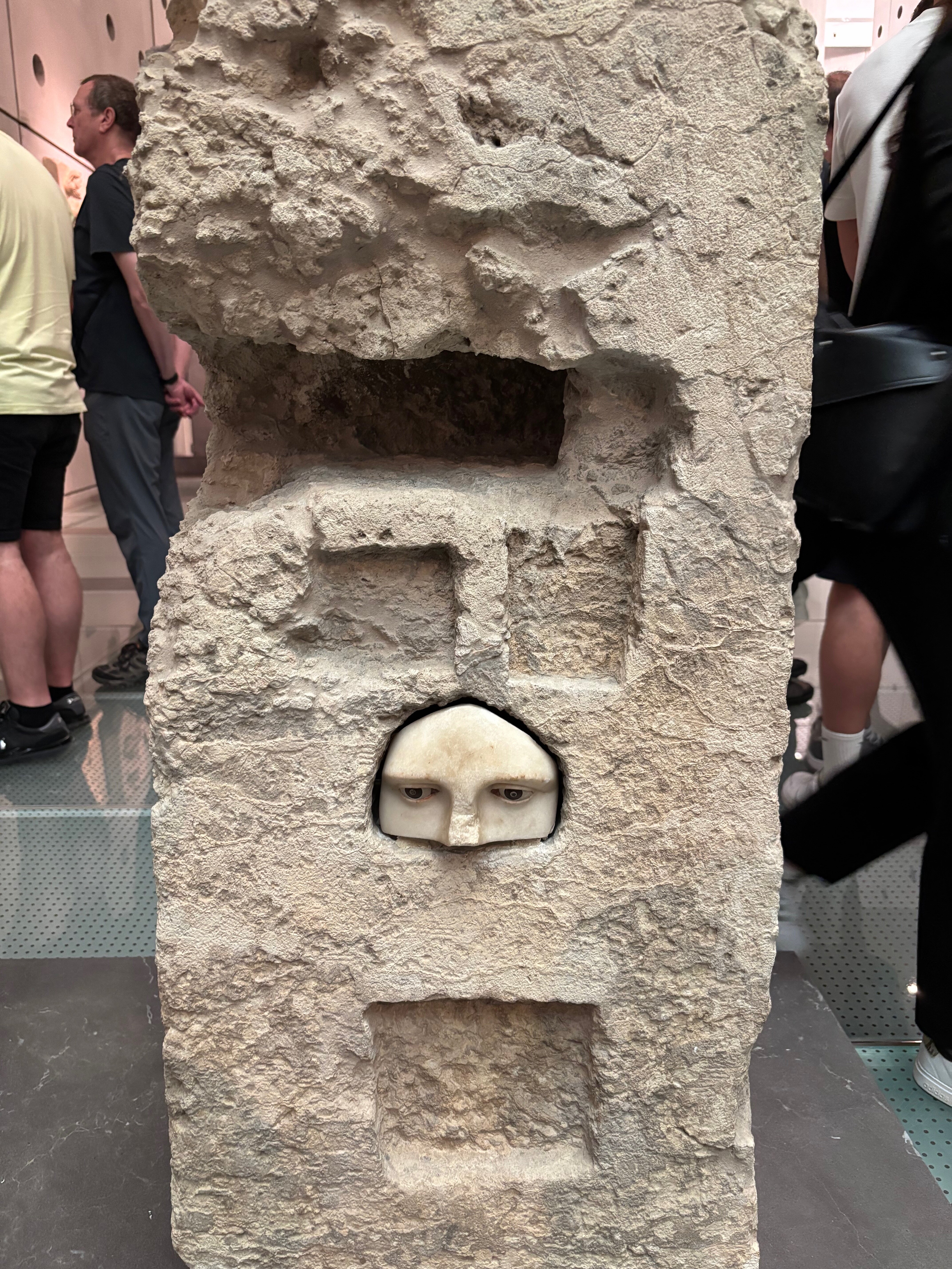 Eyes and a nose carved into a marble structure.