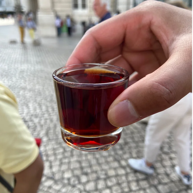 a glass with a red cherry alchohol